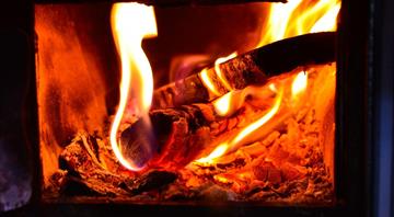 The health cost of burning wood to warm homes